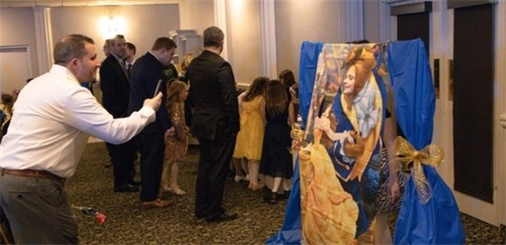Two girls pose for a photo in a photo booth