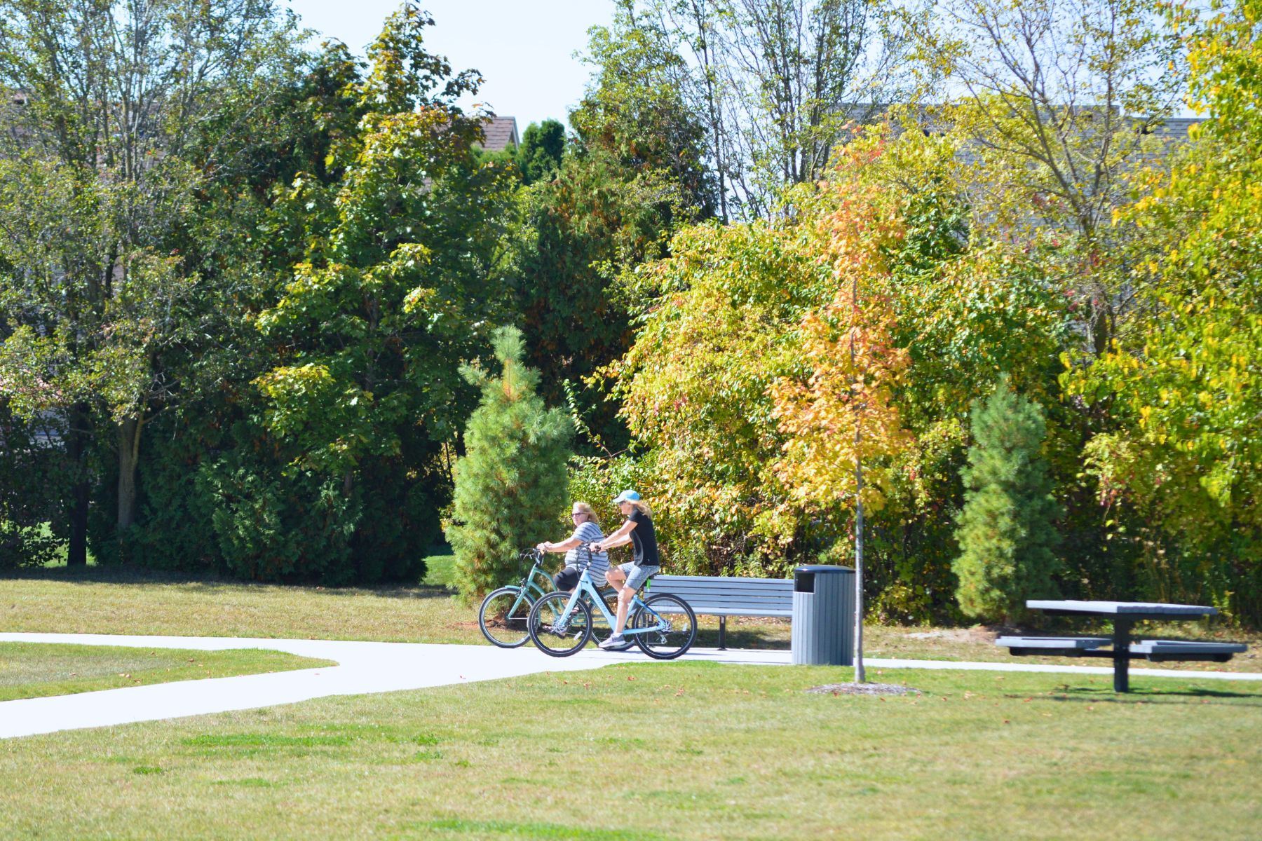Two residents riding bicycles at Pitchford Park 