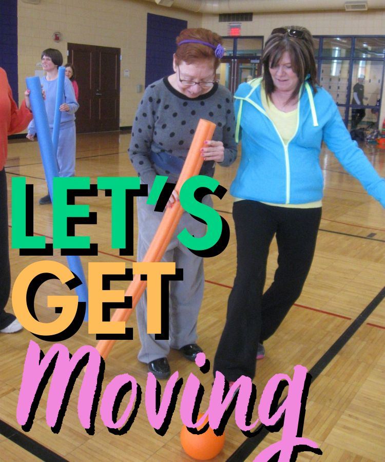 Lets Get Moving participants playing in the gym with a ball